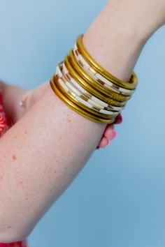 The allure of ivory enamel bangle bracelets is captured in our delicate set of six Veda bangle set for women. Available in a beautiful red & white hue. Combined with other BuDhaGirl bracelets for a modern must-have bracelet set, or create a bracelet stack with an AWB® bracelet set of your choice. Vedas are ancient Hindu texts containing wisdom delivered to priests via hymns, philosophy, and other rituals. Mindful Glamour Ritual: Pause. Breathe. Pick a mantra for your day and repeat it six times White Bangle Jewelry For Festive Occasions, Bohemian Cream Bangle Jewelry, White Stackable Bangle Jewelry, White Stackable Bangle, Bohemian Cream Bangle, Adjustable White Bangle For Festive Occasions, Adjustable White Bangle, White Bohemian Bracelets For Festive Occasions, Festive White Bohemian Bracelets