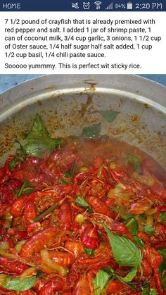 a pan filled with cooked crawfish and spinach on top of a stove