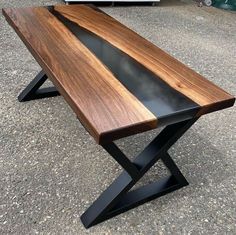 a wooden table sitting on top of a cement ground