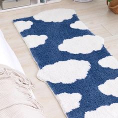 a blue and white rug with clouds on it