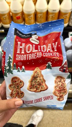 someone holding up a bag of holiday shortbread cookies