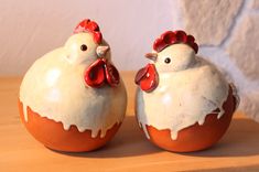 two ceramic chickens sitting on top of each other