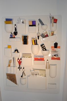 a white wall mounted with various items on it