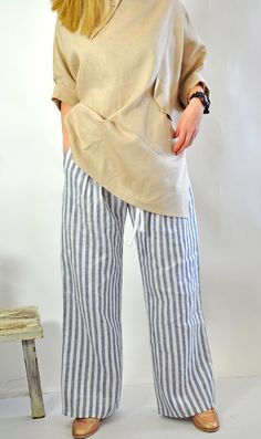 "Natural Linen White pants. Summer Loose Drop crotch Pants. Loose asymmetric linen pants. Every day comfortable pants. Maxi trousers. Cool casual pants. Striped 100% lINEN pants. Comfortable and Relaxed. Zipped pants. The style I used was originally designed and professionally constructed by me. Each item of my shop has a special package. Handmade in a pet-free and smoke- free environment. Model on picture is wearing size S Size chart Gabyga: XS (US 2, UK 6) Bust: around 33.5\" / 85 cm Waist: ar Casual Linen Harem Pants For Vacation, Baggy Linen Bottoms For Vacation, Bohemian Linen Bottoms With Pockets, Casual Flax-colored Pants For The Beach, Casual Flax-colored Pants For Beach, Casual Flax Pants For The Beach, Linen Pants With Pockets For Beach, Linen Beach Pants With Pockets, Baggy Linen Beach Pants