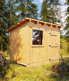 a small wooden building in the middle of a field with trees and grass around it