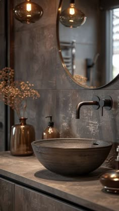 a bathroom sink sitting under a round mirror