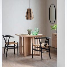 a table and chairs in a room with white walls