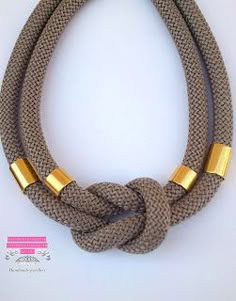 a rope necklace with two gold bars on it