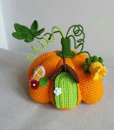 a crocheted pumpkin sitting on top of a table