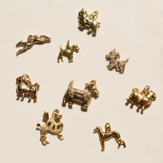 several different types of dog charms on a white surface