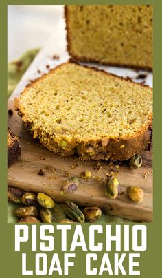 a loaf of pistachio loaf cake sitting on top of a wooden cutting board