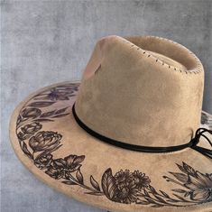 Burned Wide Brim Hat in Taupe Wide Brim Burned Hat using Pyrography techniques. Each hat is burned freehand. No Stencil, therefore each hat is a one of a kind. Each Hat is sealed with a weather proofer, good for up to 12 months. Hats made by PIPER also comes with a signature travel bag and handmade macrame Wall Hanger. Black Burned Hat, Pyrography On Hats, Painted Felt Hat, Hat Pyrography, Pyrography Techniques, Burnt Hats, Burned Hats, Hat Burning, Macrame Wall Hanger