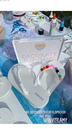 there are many flip flops for sale on the table with other items around it