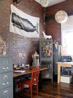 an office with brick walls and wooden floors