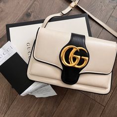 Original Box And Purchase Receipt Included. Great Condition Except For The Two Noticeable Scuffs In Pics (At Bottom Of Purse). Beautiful Beige, Black Leather With Gold Accents. Medium Size 10 In X 8 In. Beige Gucci Bag With Zipper Closure, Gucci White Bag With Removable Pouch, Elegant Gucci Bag With Gold-tone Logo Plaque, Purchase Receipt, Luxury Gucci Bag With Gold-tone Logo Plaque, Gucci Purses, Gucci Black Bag With Gold-tone Hardware, Gucci Handbags, Medium Size