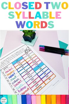 a close up of two different types of words on a table with markers and pencils