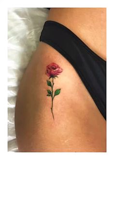 a woman's stomach with a rose tattoo on it