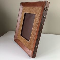 a brown and tan frame sitting on top of a white table