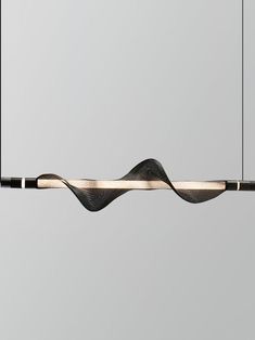 a black and white light hanging from a ceiling