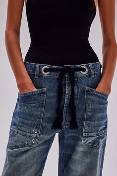 The perfect cool & contemporary addition to any denim drawer from our We The Free collection. **Fit:** Low-slung, slouchy fit with tapered silhouette **Features:** Distressed detailing throughout, paint splatter features, oversized patch pockets, contrast drawstring waist, pull-on style **Why We | We The Free Moxie Pull-On Barrel Jeans at Free People in Medium Wash, Size: 30 L Barrel Jeans, Nye Outfits, Blue Fits, Denim Jumpsuit, Paint Splatter, Western Outfits, Boho Clothing, Western Wear, Hat Hairstyles