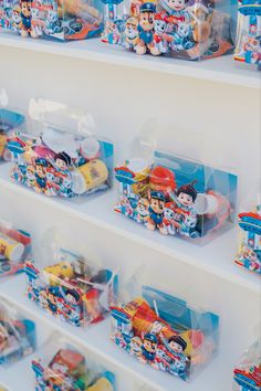 shelves filled with toys and other items on top of each other in plastic containers,