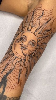 a man with a sun tattoo on his arm