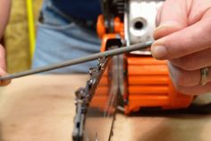 two people are working on some kind of thing with wires and screwdrivers in their hands