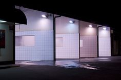 an empty parking lot at night with lights on