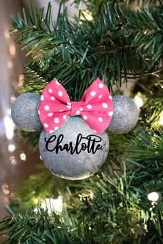 a minnie mouse ornament hanging from a christmas tree with the name charlotte on it