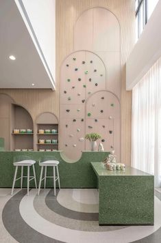 the interior of a store with green counter tops and stools