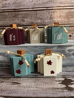 four small wooden blocks with the words fall and y'all painted on them