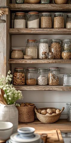 the shelves are filled with many different types of food in glass jars and baskets on them