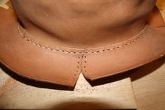 a close up of a person's shoe on a wooden surface