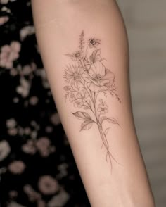 a woman's arm with flowers on it