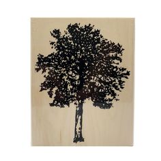 a wooden plaque with a black tree on it's front and back sides, in the shape of a rectangle