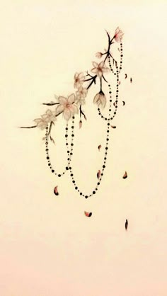 a drawing of flowers with beads hanging from it's stems on a white wall