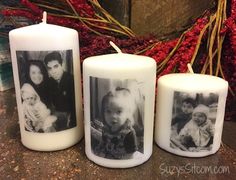 three white candles with photos on them