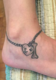 a foot with a tattoo on it that has a cross and a heart in the middle