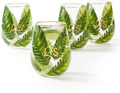 four green stemless wine glasses with leaves and the word s is on them, set against a white background