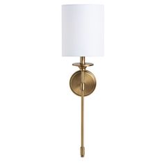 a brass wall light with a white shade