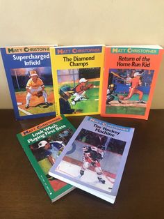 four books about baseball are sitting on a table