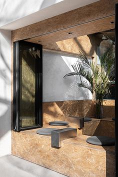 an outdoor area with concrete benches and potted plants