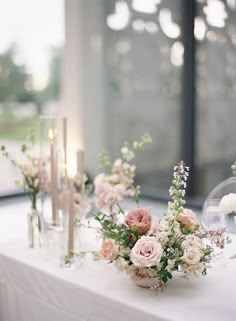 a table with flowers and candles on it