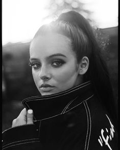 a black and white photo of a woman with long hair