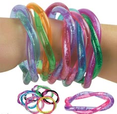 a person's arm with several bracelets on it and one in the foreground