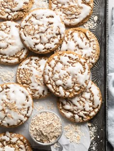 a tray filled with cookies covered in white icing