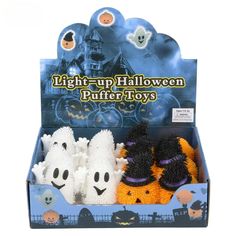 three halloween toys in a display box with ghost faces and pumpkins on the front