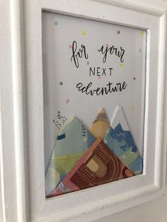 a white frame with some paper cutouts in it that says for your next adventure