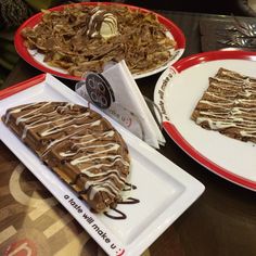 three plates with desserts on them are sitting on a table in front of each other