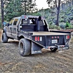 a large truck is parked in the dirt